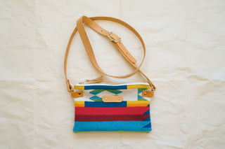 Pendleton wool zipper pouch in Candy Mountain, customized with a leather tab and an adjustable leather crossbody strap